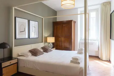 a bedroom with a large bed with towels on it at EasyTopStay - Piazza Navona Charming Apartment in Rome