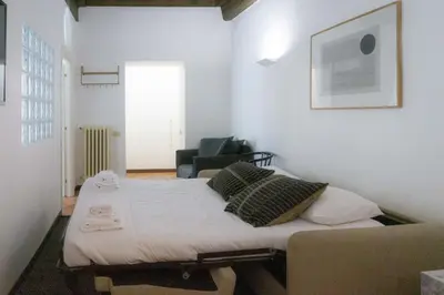 a bed in a room with a couch and a chair at EasyTopStay - Piazza Navona Charming Apartment in Rome
