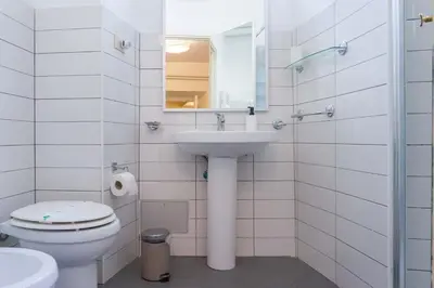 a white bathroom with a sink and a toilet at EasyTopStay - Piazza Navona Charming Apartment in Rome