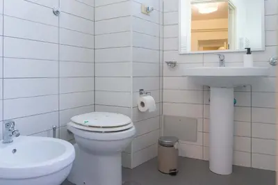 a white bathroom with a toilet and a sink at EasyTopStay - Piazza Navona Charming Apartment in Rome