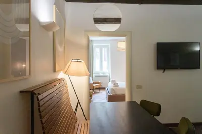 a living room with a dining room table and a television at EasyTopStay - Piazza Navona Charming Apartment in Rome