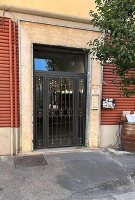 a door to a building with black doors at La Maison D'Amelia in Rome