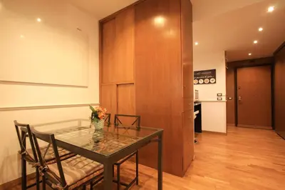 a dining room with a glass table and chairs at Giulio Cesare Holiday House in Rome