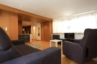 a living room with two couches and a television at Giulio Cesare Holiday House in Rome