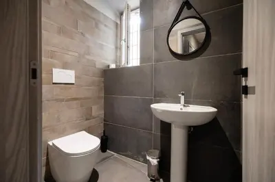 a bathroom with a sink and a toilet and a mirror at Borgo Ripa Urban Travel in Rome