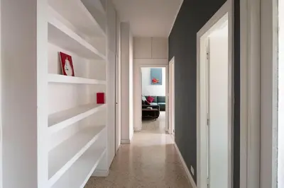 a hallway with white shelves in a house at Nel cuore di Monteverde in Rome