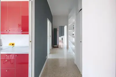 a kitchen with red cabinets and a white counter at Nel cuore di Monteverde in Rome