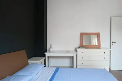 a bedroom with a bed and a dresser and a mirror at Nel cuore di Monteverde in Rome