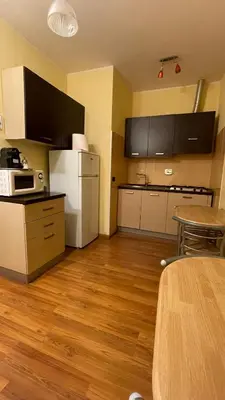 a room with a kitchen with a table and a microwave at Holiday Suite Roma in Rome