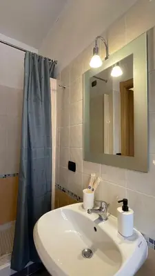 a bathroom with a sink and a mirror at Holiday Suite Roma in Rome