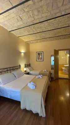 a bedroom with two beds with towels on them at Holiday Suite Roma in Rome
