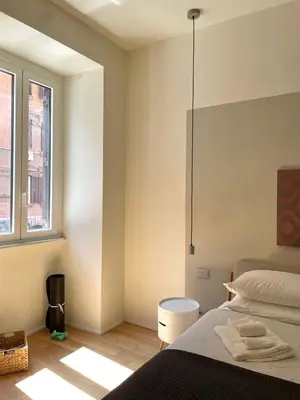 a bedroom with a bed and a window at La Dolce Vita - Old Testaccio Luxury Apartment in Rome
