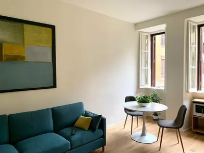 a living room with a blue couch and a table at La Dolce Vita - Old Testaccio Luxury Apartment in Rome