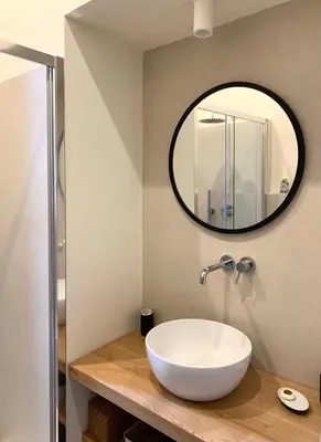 a bathroom with a white sink and a mirror at La Dolce Vita - Old Testaccio Luxury Apartment in Rome