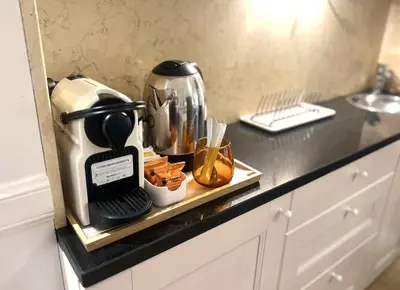 a kitchen counter with a coffee maker on a tray at INTERNO ROMA in Rome