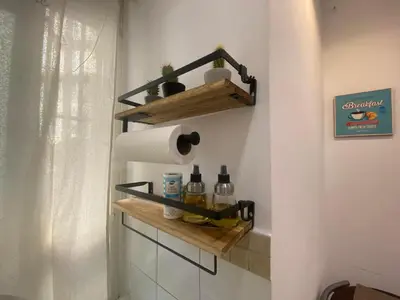 a bathroom with a shelf with toilet paper and bottles at La casa dell’Appio in Rome