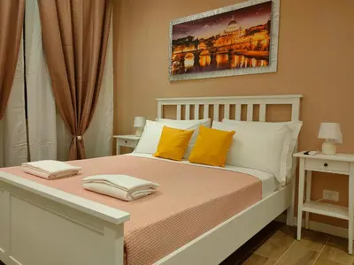 a bedroom with a bed with yellow and white pillows at BePlace Holy See in Rome