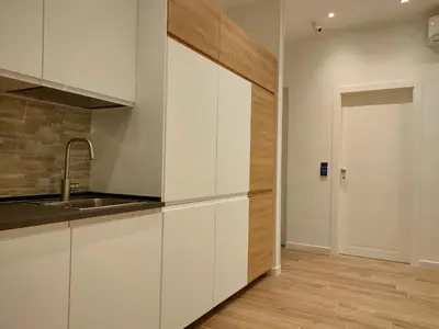 a kitchen with white cabinets and a sink at BePlace Holy See in Rome