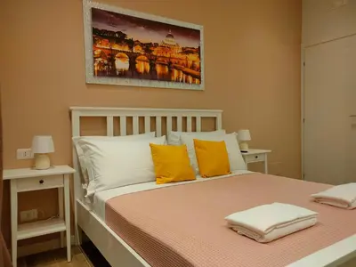a bedroom with a bed with orange and white pillows at BePlace Holy See in Rome