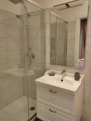 a bathroom with a white sink and a shower at BePlace Holy See in Rome