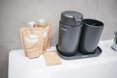 a counter top with a coffee maker and two trash cans at Vatican Museum Apartment in Rome