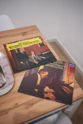 a wooden table with two magazines on top of it at Vatican Museum Apartment in Rome