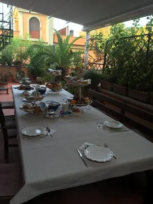a table with plates of food on a patio at Trastevere Belvedere B&B in Rome