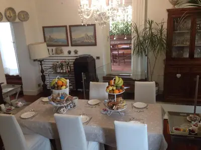 a dining room table with bowls of fruit on it at Trastevere Belvedere B&B in Rome