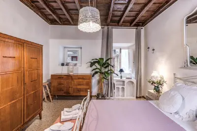 a bedroom with a bed and a dresser and a mirror at Capocci Luxury Home in Rome