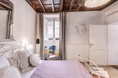 a bedroom with a white bed and a mirror at Capocci Luxury Home in Rome