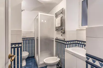 a bathroom with a shower and a toilet and a sink at Capocci Luxury Home in Rome