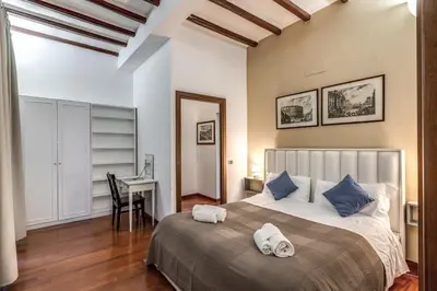 a bedroom with a bed with two towels on it at MyRHome - Spanish Steps in Rome