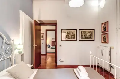 a white room with a bed and a hallway at MyRHome - Spanish Steps in Rome