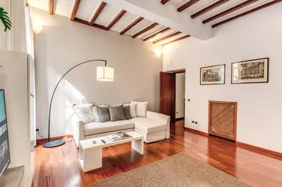 a living room with a white couch and a table at MyRHome - Spanish Steps in Rome