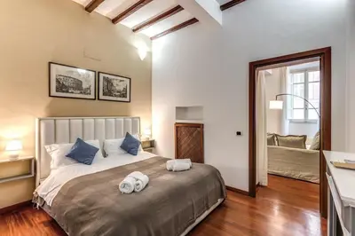 a bedroom with a large bed with towels on it at MyRHome - Spanish Steps in Rome