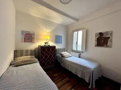 a room with two beds and a window at Giglio Penthouse and Terrace in Rome