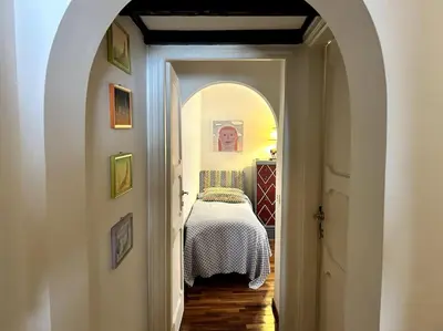 a hallway leading to a bedroom with a bed at Giglio Penthouse and Terrace in Rome
