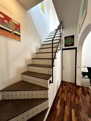 a staircase in a room with a stair case at Giglio Penthouse and Terrace in Rome