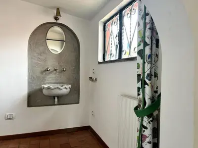 a bathroom with a sink with a mirror on the wall at Giglio Penthouse and Terrace in Rome