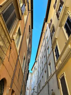 an alley between two buildings in a city at Giglio Penthouse and Terrace in Rome