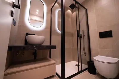 a bathroom with a shower and a sink and a toilet at Scipioni Luxury Suite in Rome