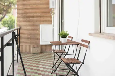 a table and two chairs on a porch with a plant at Vatican Suite Apartament Roma in Rome