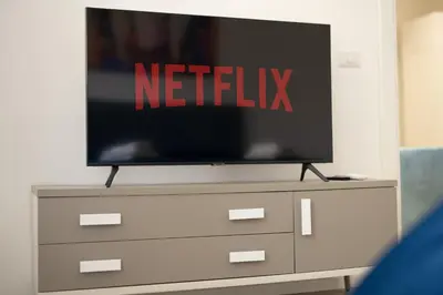 a television sitting on top of a dresser at Vatican Suite Apartament Roma in Rome