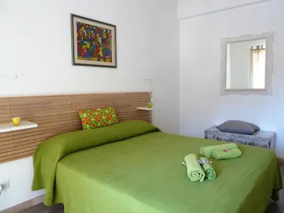 a bedroom with a green bed and a window at Stesi Vacanze in Rome