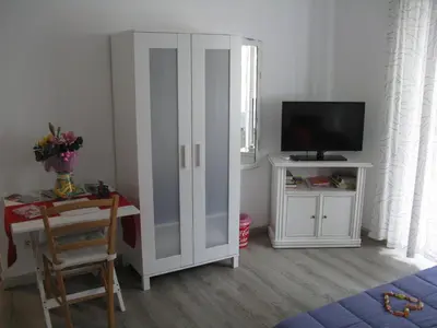 a living room with a white cabinet and a tv at Stesi Vacanze in Rome