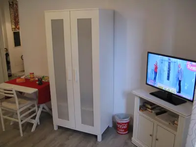 a living room with a tv and a table with a table at Stesi Vacanze in Rome
