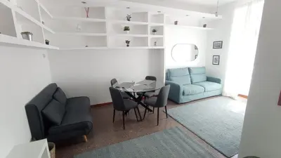 a living room with a table and chairs and a couch at Antinori Testaccio Cozy Apartment in Rome