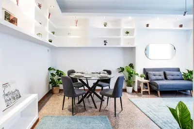 a dining room with a table and chairs and a couch at Antinori Testaccio Cozy Apartment in Rome