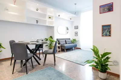 a dining room and living room with a table and chairs at Antinori Testaccio Cozy Apartment in Rome