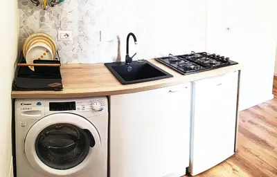 a kitchen with a sink and a washing machine at Germanico Apartments in Rome